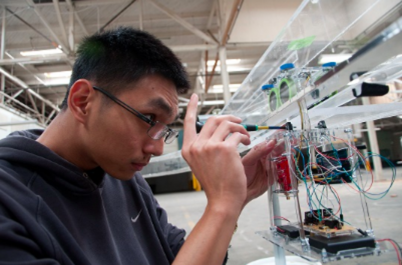 Student engineer works on bogie prototype.